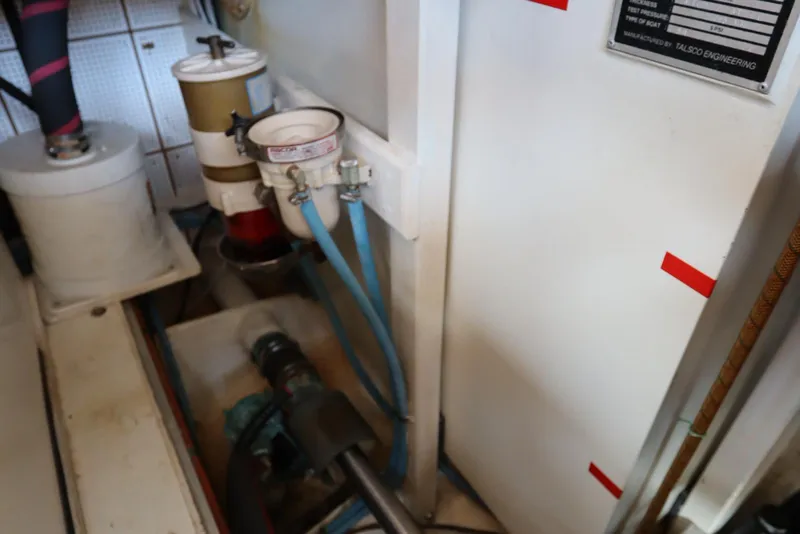 Slide: The Image of Engine room of 1993 Grand Banks 46 Classic, featuring pipes and filtration system. - 113