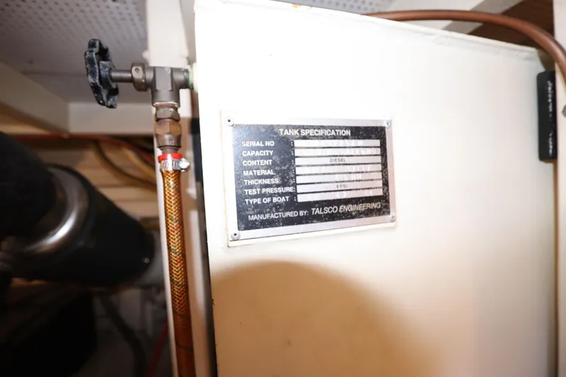 Slide: The Image of Engine room of 1993 Grand Banks 46 Classic with tank specification plate. - 115