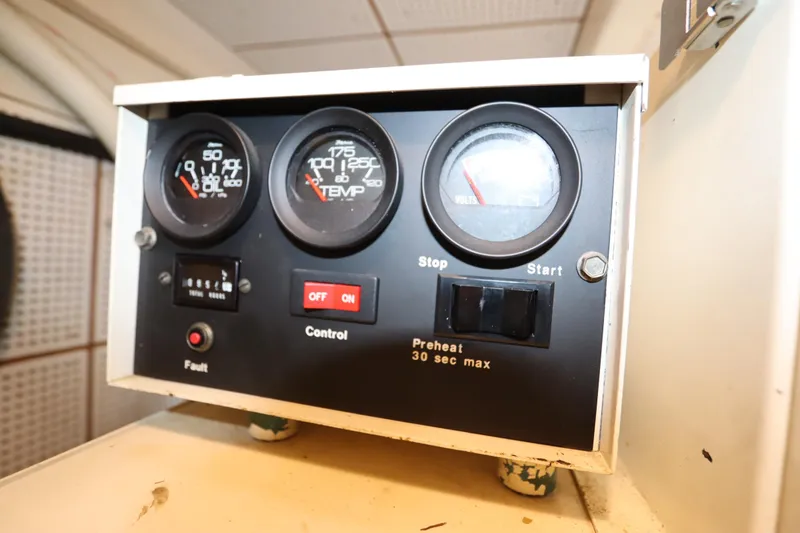 Slide: The Image of Control panel of a 1993 Grand Banks 46 Classic boat, featuring gauges and switches. - 117