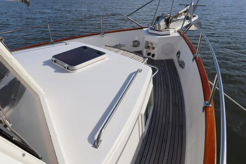 Slide: The Image of 1993 Grand Banks 46 Classic yacht deck with wooden railings and ocean view. - 12