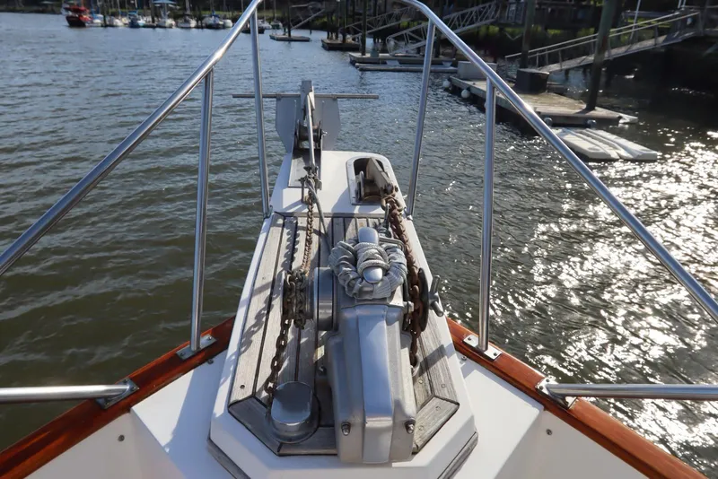 Slide: The Image of Bow of 1993 Grand Banks 46 Classic yacht with anchor chain and water view. - 13