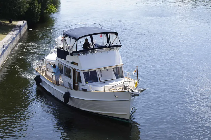 Slide: The Image of Grand Banks 42 Classic 1993 yacht cruising on a calm river. - 130