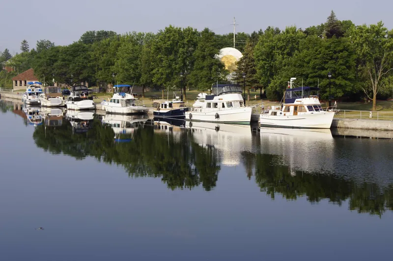 Slide: The Image of Boats docked along a calm river, featuring a 1993 Grand Banks 42 Classic. - 135