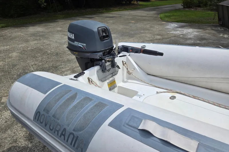 Slide: The Image of Novurania inflatable boat with Yamaha outboard motor, parked on concrete driveway. - 139