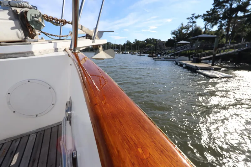 Slide: The Image of Polished wood railing on 1993 Grand Banks 46 Classic yacht, docked by a scenic waterfront. - 15