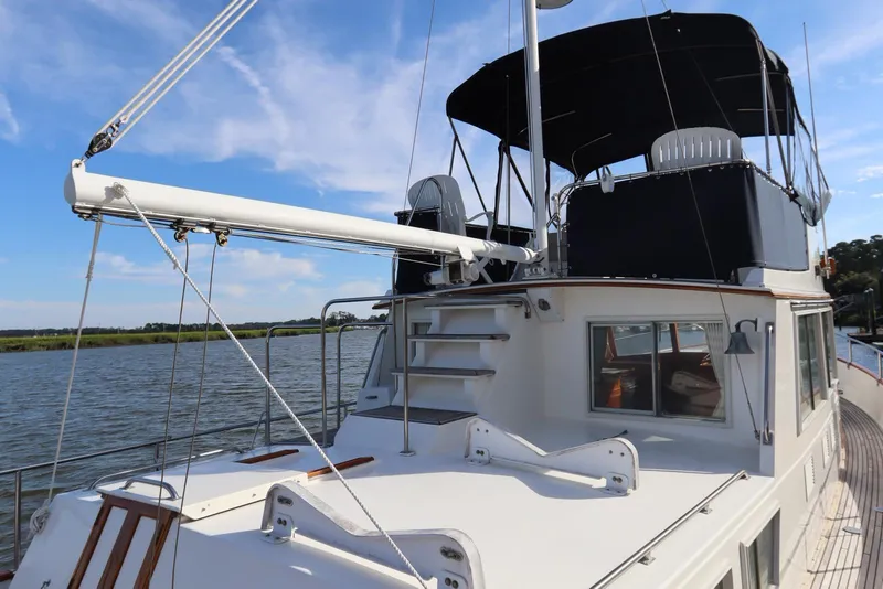 Slide: The Image of 1993 Grand Banks 46 Classic yacht with upper deck and canopy on a sunny day. - 18