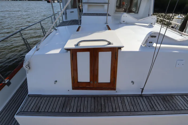 Slide: The Image of 1993 Grand Banks 46 Classic yacht deck with wooden doors and railing. - 19