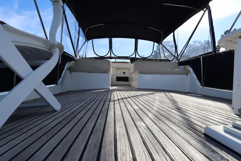 Slide: The Image of 1993 Grand Banks 46 Classic yacht deck with seating and canopy, showcasing elegant wooden flooring. - 21