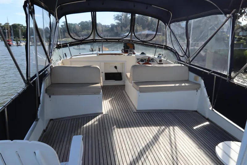 Slide: The Image of 1993 Grand Banks 46 Classic yacht interior with seating and helm, docked by the water. - 22