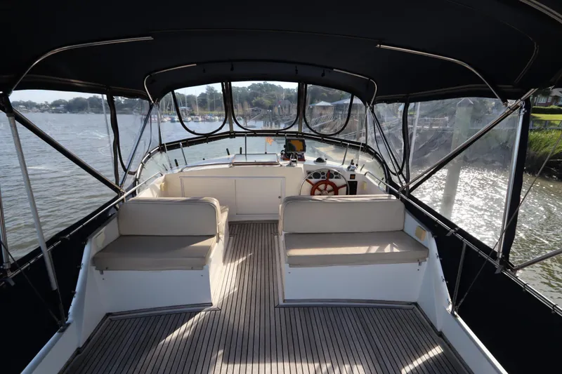 Slide: The Image of 1993 Grand Banks 46 Classic yacht interior with helm, seating, and panoramic water views. - 24