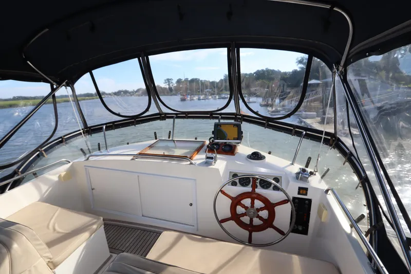 Slide: The Image of Interior view of 1993 Grand Banks 46 Classic yacht helm with wooden steering wheel. - 25