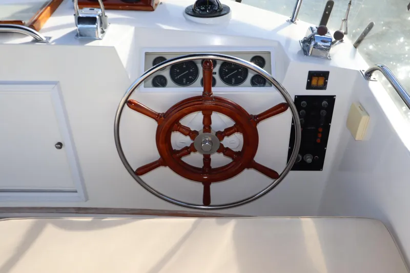 Slide: The Image of Steering wheel of a 1993 Grand Banks 46 Classic yacht, featuring classic nautical design. - 26