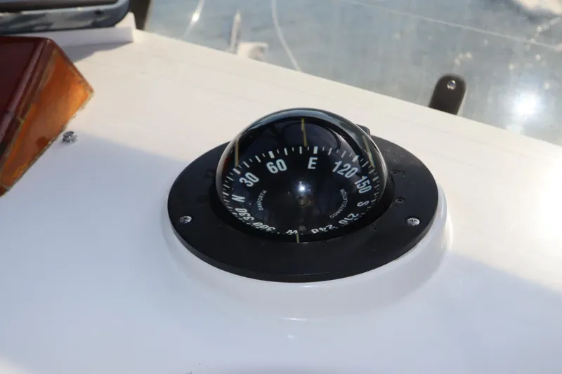Slide: The Image of Compass on 1993 Grand Banks 46 Classic yacht dashboard, showing cardinal directions. - 31