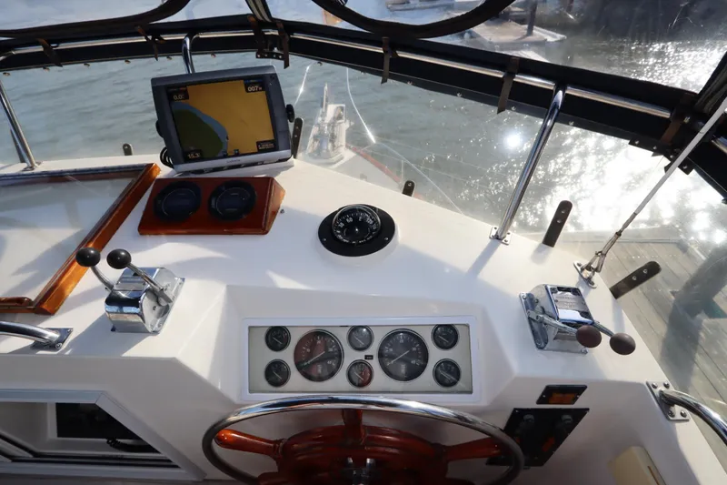 Slide: The Image of Helm of 1993 Grand Banks 46 Classic yacht with navigation instruments and controls. - 32