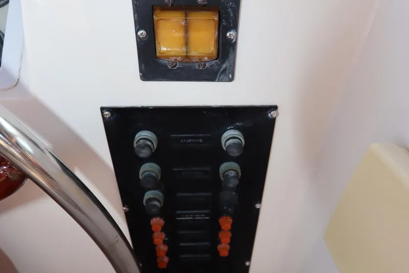 Slide: The Image of Control panel of 1993 Grand Banks 46 Classic yacht with switches and buttons. - 33