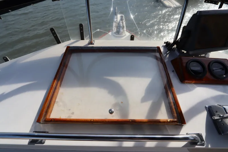 Slide: The Image of Helm station of 1993 Grand Banks 46 Classic yacht with wooden trim and gauges. - 35