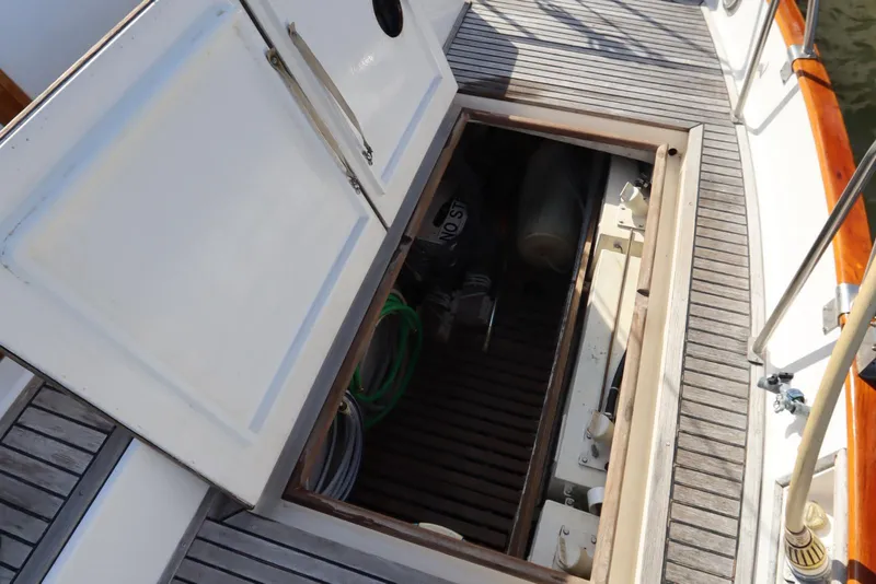 Slide: The Image of Open hatch on 1993 Grand Banks 46 Classic boat deck, revealing storage compartment. - 39