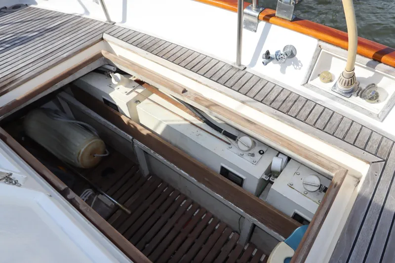 Slide: The Image of 1993 Grand Banks 46 Classic yacht deck with open storage compartment and wooden flooring. - 40