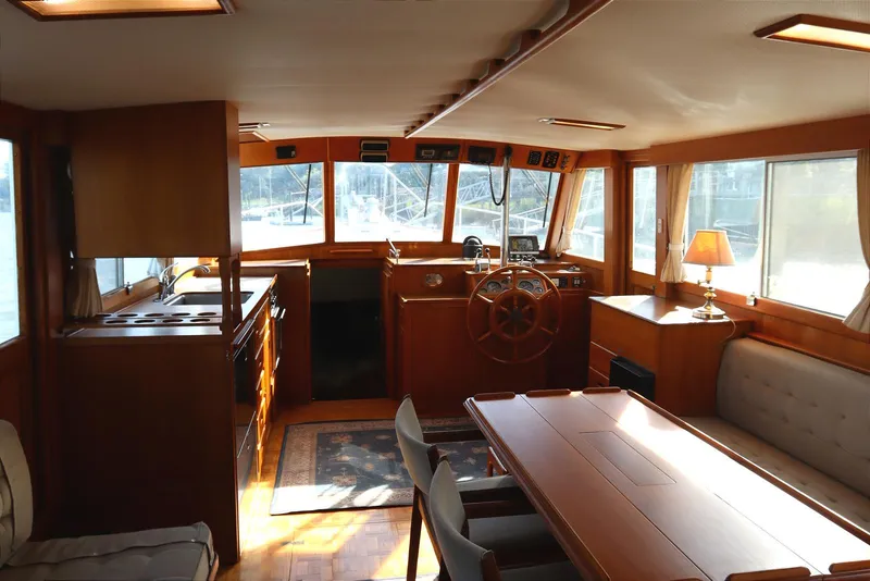 Slide: The Image of Interior of 1993 Grand Banks 46 Classic yacht with wooden furnishings and helm station. - 42