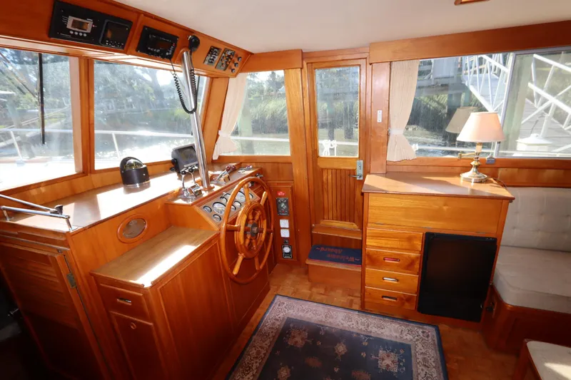 Slide: The Image of Interior of 1993 Grand Banks 46 Classic yacht with wooden helm and cozy furnishings. - 43