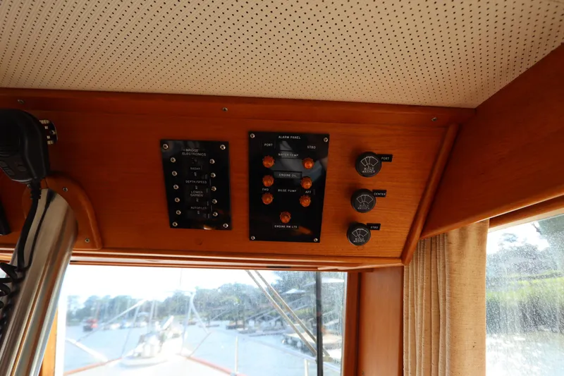Slide: The Image of Control panel inside 1993 Grand Banks 46 Classic yacht, featuring switches and gauges. - 48