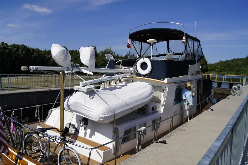 Slide: The Image of Grand Banks 42 Classic yacht docked, 1993 model, with bicycles and lifeboat on deck. - 5