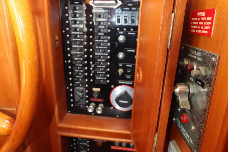 Slide: The Image of Electrical panel inside a 1993 Grand Banks 46 Classic boat, featuring switches and controls. - 51