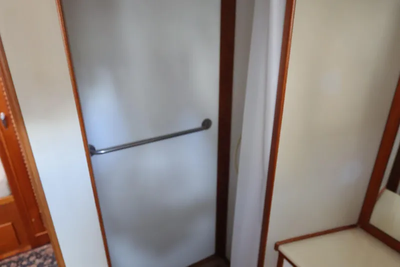 Slide: The Image of Interior of 1993 Grand Banks 46 Classic yacht, featuring a shower area with a towel rail. - 60