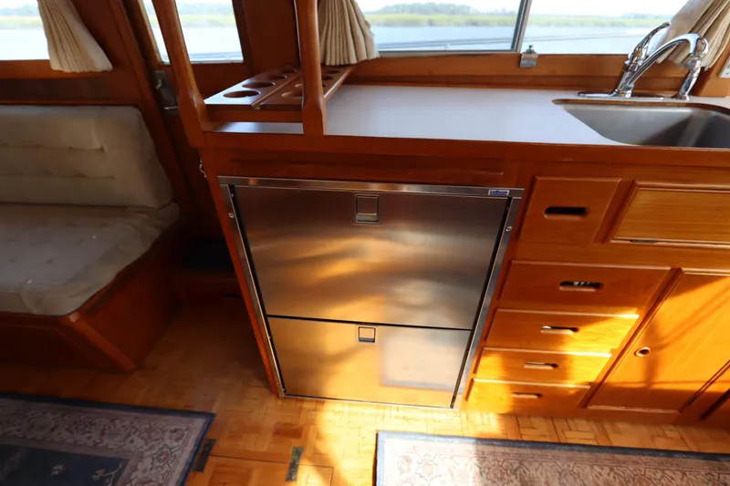 Slide: The Image of Interior of 1993 Grand Banks 46 Classic yacht with wooden cabinetry and stainless steel appliances. - 61