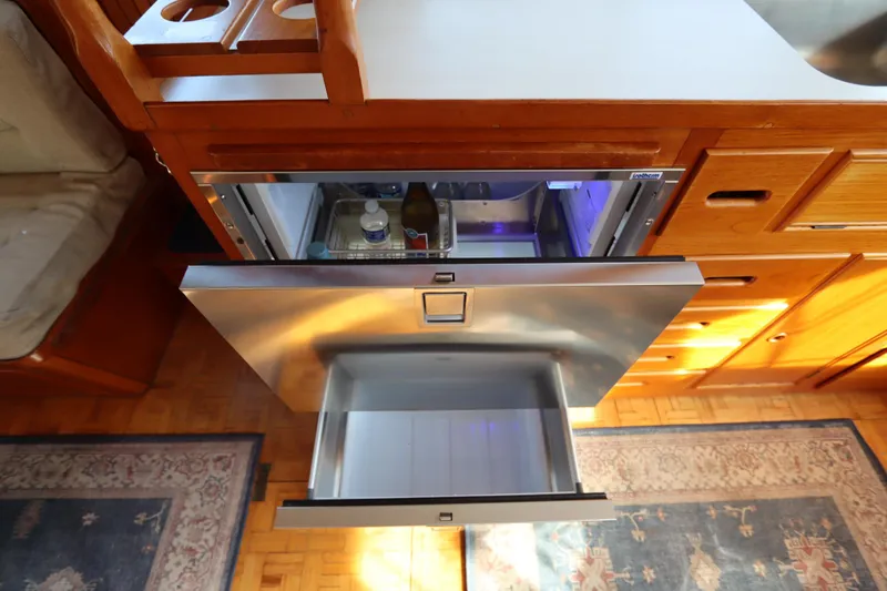 Slide: The Image of 1993 Grand Banks 46 Classic yacht interior with open stainless steel refrigerator drawer. - 62
