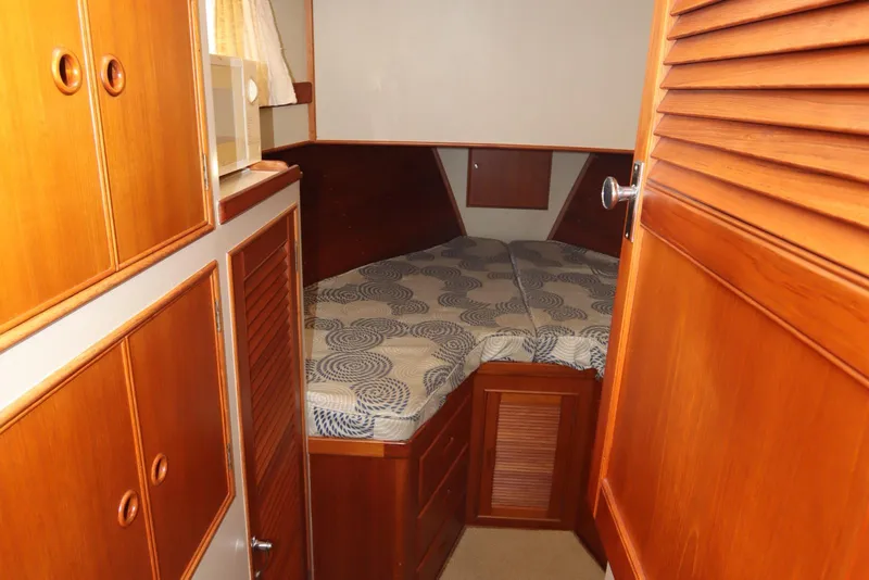 Slide: The Image of 1993 Grand Banks 46 Classic cabin with wooden interior and cozy bed. - 65