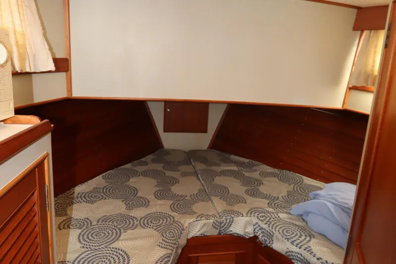 Slide: The Image of Cozy cabin interior of 1993 Grand Banks 46 Classic yacht with patterned bedding. - 66