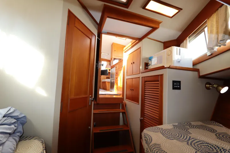 Slide: The Image of Interior of 1993 Grand Banks 46 Classic yacht, featuring wooden cabinetry and cozy sleeping area. - 69