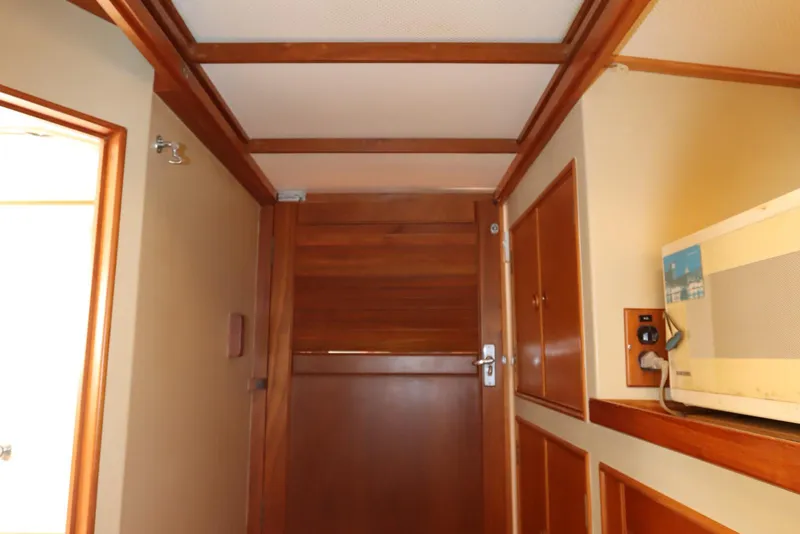 Slide: The Image of Interior of 1993 Grand Banks 46 Classic yacht, featuring wooden door and paneling. - 70
