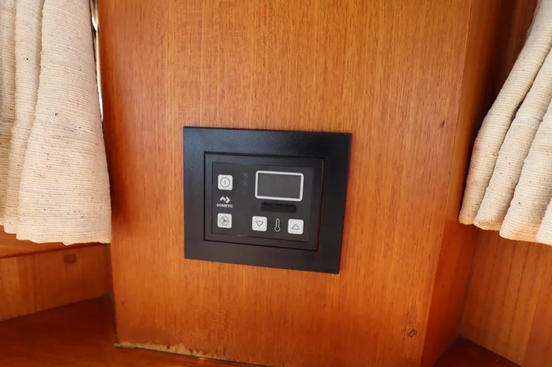 Slide: The Image of Control panel on 1993 Grand Banks 46 Classic yacht, mounted on wooden interior. - 71