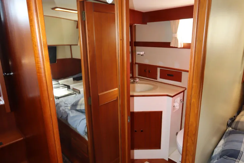 Slide: The Image of Interior of 1993 Grand Banks 46 Classic yacht, featuring a cozy cabin and bathroom. - 79