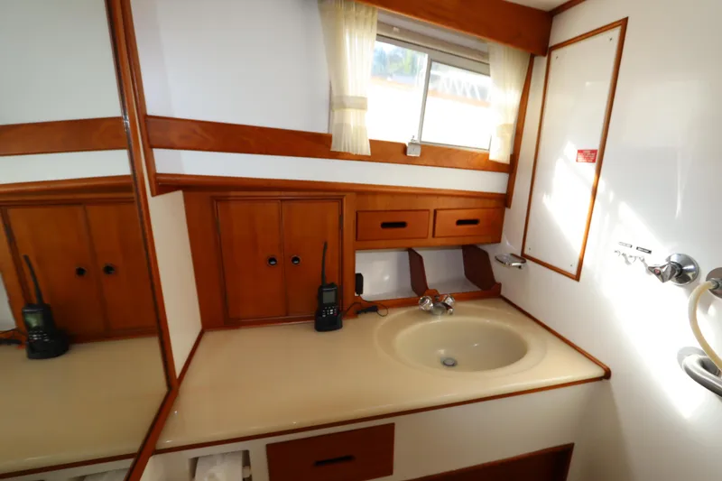 Slide: The Image of Bathroom interior of 1993 Grand Banks 46 Classic yacht with wooden cabinetry and sink. - 80