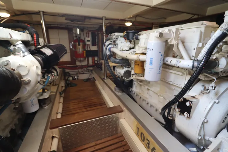 Slide: The Image of Engine room of 1993 Grand Banks 46 Classic yacht, showcasing dual engines and equipment. - 87