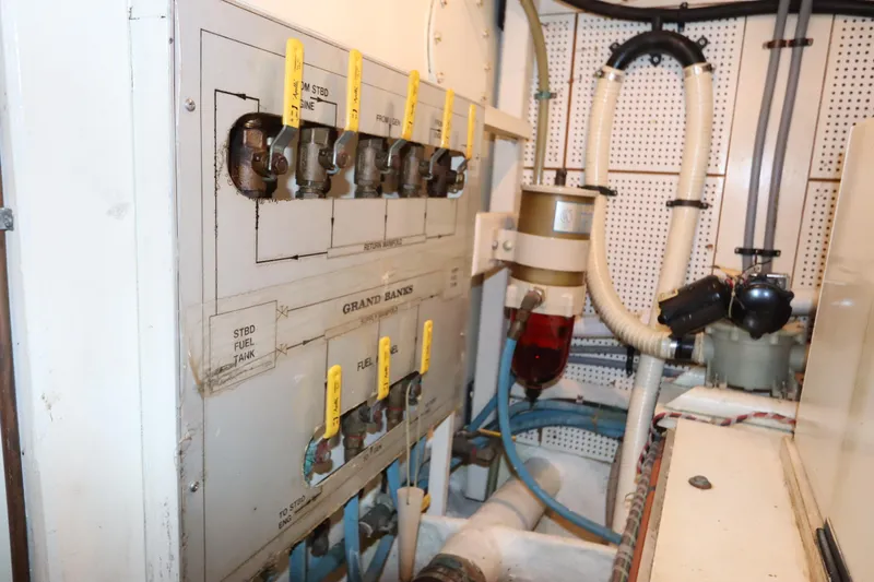Slide: The Image of Engine room of 1993 Grand Banks 46 Classic with fuel system controls and valves. - 90
