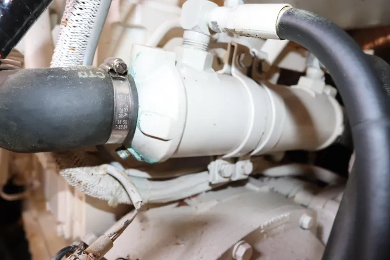 Slide: The Image of Engine component of 1993 Grand Banks 46 Classic boat, featuring hoses and clamps. - 92