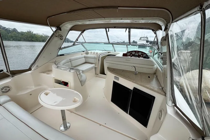 Slide: The Image of 2005 Rinker Fiesta Vee 342 boat interior with seating, table, and helm. - 11