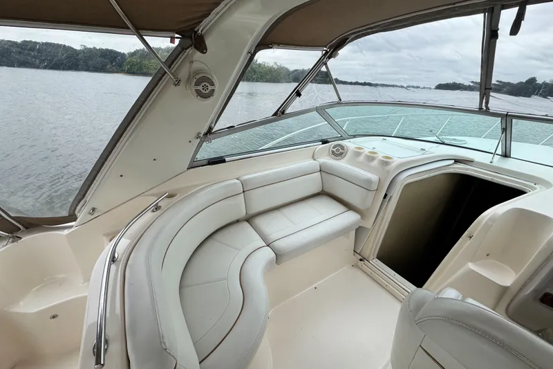 Slide: The Image of 2005 Rinker Fiesta Vee 342 boat interior with white seating and open cabin door. - 15