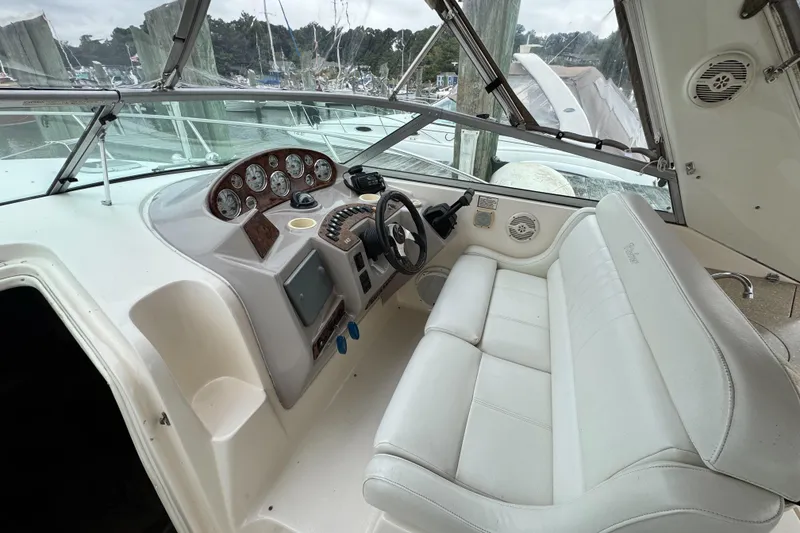 Slide: The Image of 2005 Rinker Fiesta Vee 342 boat cockpit with white seating and control panel. - 16