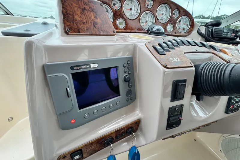 Slide: The Image of 2005 Rinker Fiesta Vee 342 dashboard with Raymarine C70 display and control panel. - 18
