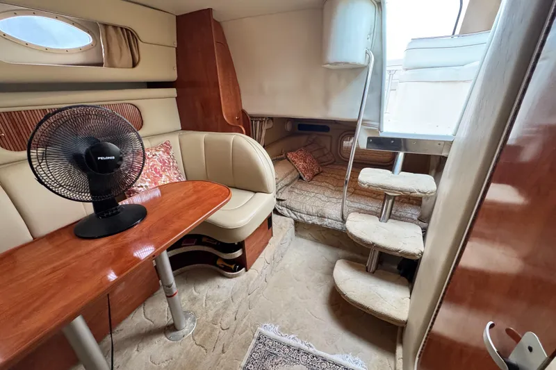 Slide: The Image of 2005 Rinker Fiesta Vee 342 cabin interior with seating, table, and stairs. - 22