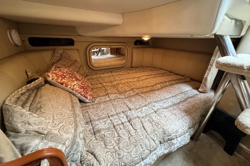 Slide: The Image of 2005 Rinker Fiesta Vee 342 cabin interior with cozy bed and patterned bedding. - 24