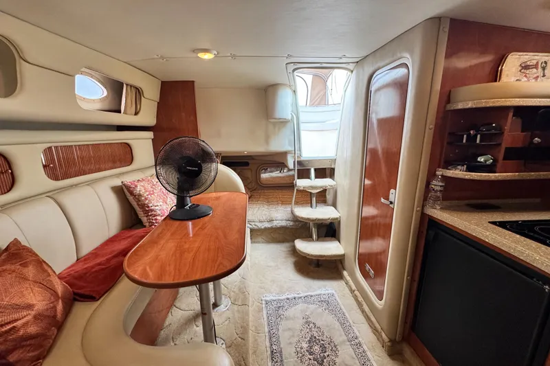 Slide: The Image of Interior of 2005 Rinker Fiesta Vee 342 boat with cozy seating and kitchenette. - 29