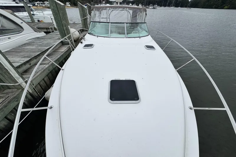 Slide: The Image of 2005 Rinker Fiesta Vee 342 boat docked at marina, viewed from bow. - 6