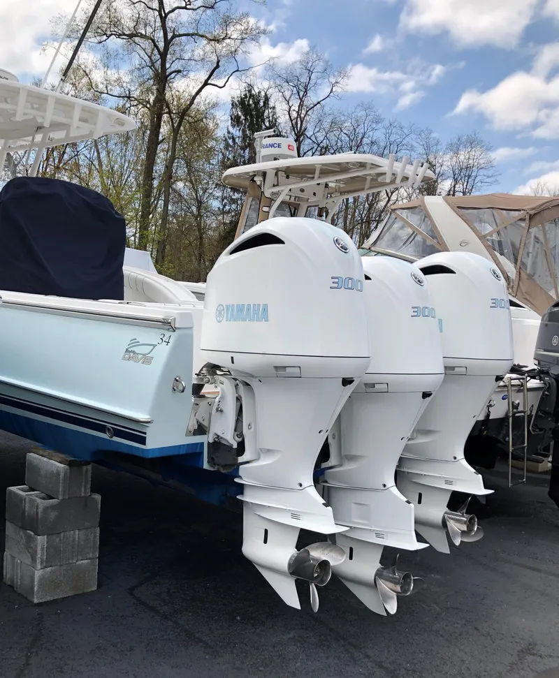 Slide: The Image of 2017 Buddy Davis 34 Center Console boat with triple outboard engines on display. - 12