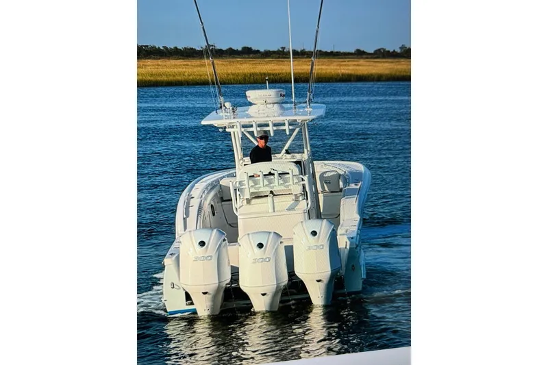 Slide: The Image of 2017 Buddy Davis 34 Center Console boat with triple 300 engines on water. - 6